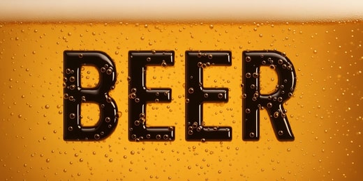 Text flouting in pint of beer.